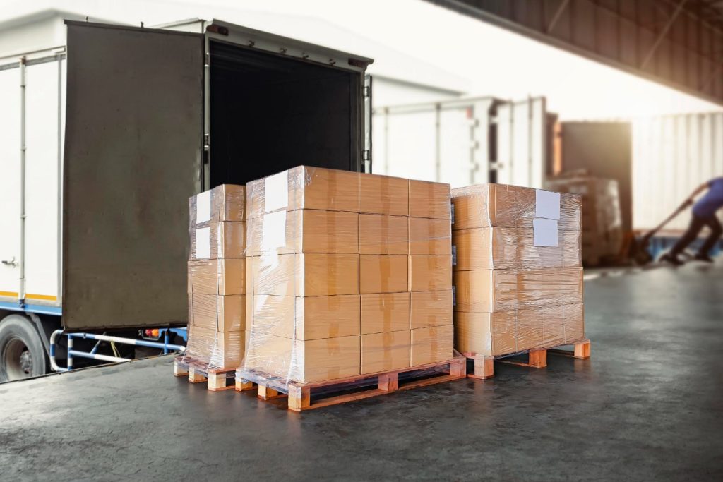 packaging-boxes-wrapped-plastic-pallets-loading-into-cargo-container-delivery-trucks-logistics